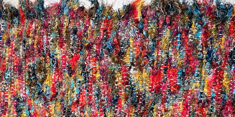 a colorful, textured rag rug runner